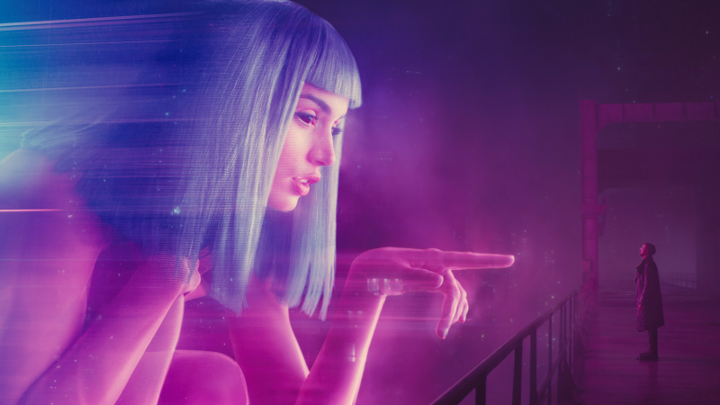 Ryan Gosling as Officer K looking at a holographic advertisment